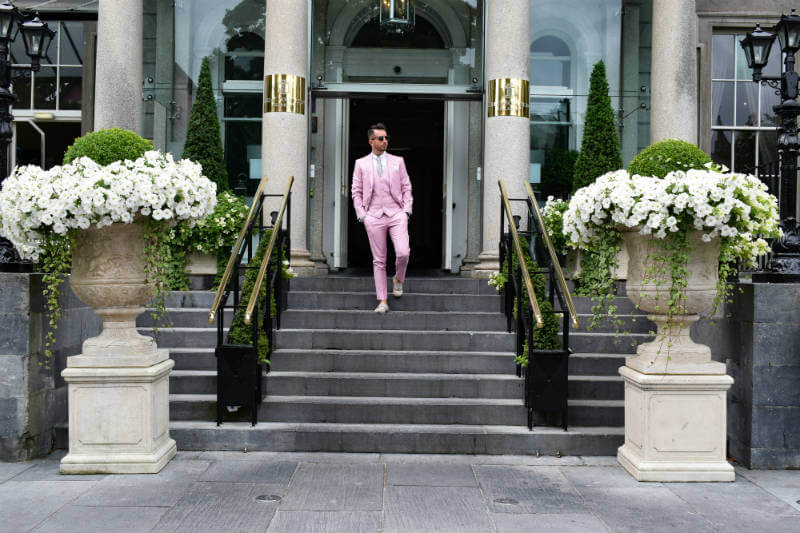 Walking down steps in a Pink Suit